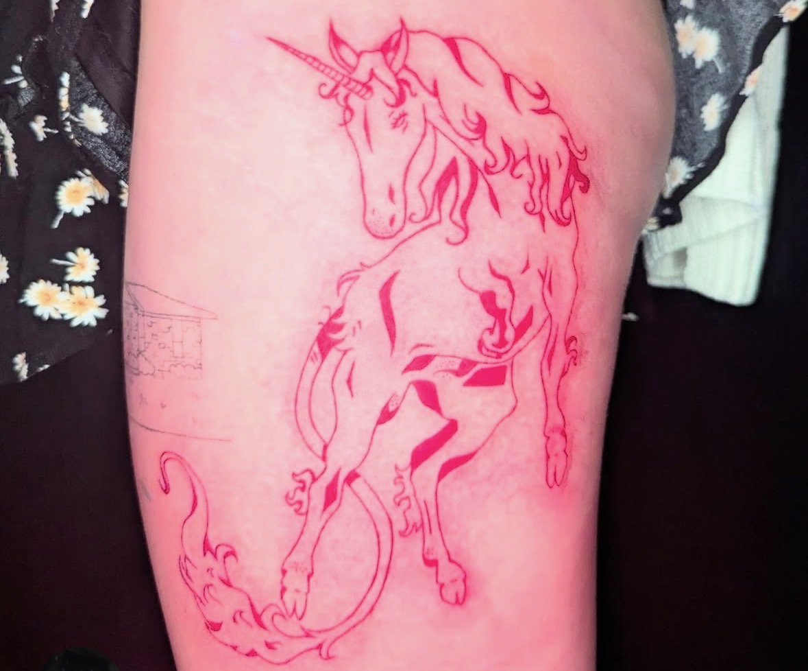 Red ink unicorn tattoo