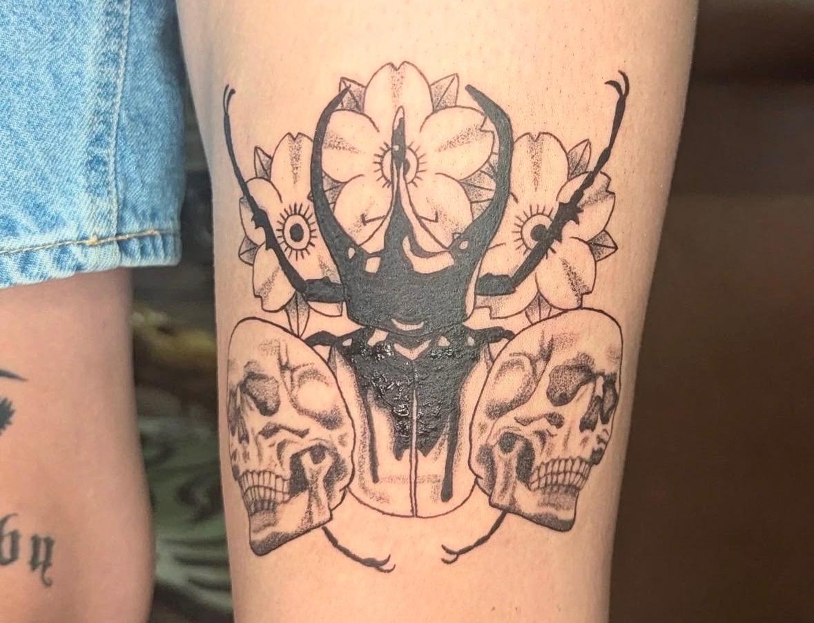 Beetle with skulls and flowers tattoo