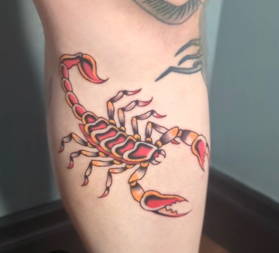Red and gold scorpion tattoo
